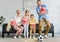 excited family with two kids holding boxes and throwing popcorn