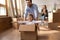 Excited father have fun with little son on moving day