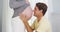 Excited father kissing pregnant wife\'s belly