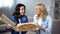 Excited female friends with huge delicious pizza, food delivery service, home