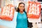 Excited Female Shopper With Sale Bags In Mall