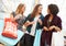 Excited Female Shoppers With Sale Bags In Mall