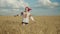 Excited female spinning around in wheat field