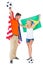 Excited football fan couple holding usa and brazils flag