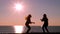 Excited friends jumping at sunrise on the beach