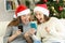 Excited friends watching phone content on christmas