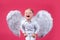 Excited funny angel children boy with white wings laughing. Valentines day cupid child.