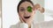 Excited funny girl vegan holding parsley looking at camera