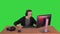 Excited gamer playing online video game on a green screen, chroma key.