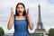 Excited girl on Eiffel Tower background.