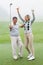 Excited golfing couple cheering