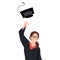 Excited graduate in cloak and graduation hat. Caucasian graduate throwing up hat. Cheerful female graduate with hands raised