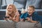 excited grandmother and grandson playing video game with joysticks