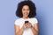 Excited happy african american millennial lady holding mobile phone.