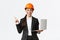 Excited happy asian female engineer, industrial woman in safety helmet and business suit, showing presentation, pointing