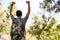 Excited and happy Asian male traveler hands up, raising hands, reaching at his destination