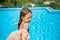 Excited happy little girl leading parent by the hand jumping into the swimming pool. Happy summer vacation. Follow me concept.