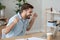 Excited happy man sitting at the desk looking at laptop