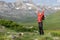 Excited hiker raising arms celebrating vacation in nature