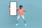 Excited hindu guy jumping up with smartphone, mockup