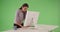 Excited Hispanic business woman raising arms and celebrating at computer desk