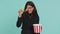 Excited indian woman eating popcorn, watching interesting tv serial, sport game, film, online movie