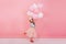 Excited joyful amazing girl with long brunette hair, in princess mask on head jumping in tulle skirt with flying