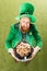 Excited leprechaun holding pot of gold