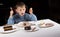 Excited little boy eyeing a choice of cakes