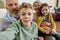 Excited little boy making a selfie with family at home, cheerful grandparent spending time with grandchildren, playing