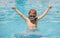 Excited little child boy in sunglasses in pool in summer day. Child boy swim in swimming pool.