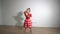 Excited little girl dancing with dress and shadow on background. Gimbal motion