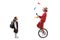 Excited little schoolgirl looking at a mime juggling and riding a unicycle
