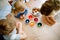 Excited little toddler girl and two kids boys coloring eggs for Easter. Three children, siblings looking surprised at