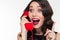 Excited lovely cute woman in retro style talking on telephone
