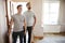 Excited Male Couple Opening Front Door Of New Home