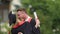 Excited male and female university graduates exchanging congratulations, hugging