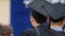 Excited male student waiting for his turn to receive higher education diploma