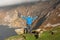 Excited male tourist with his hand up in the air enjoys stunning view of amazing scenery of Slieve League Cliff in County Donegal