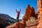 Excited man celebrating hiking in the red rock formations of Southern Utah