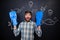 Excited man with flippers on hands standing over blackboard background