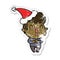 excited man hand drawn distressed sticker cartoon of a wearing santa hat