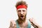 Excited man in red headband cheering for his soccer team, isolated on white.