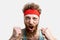 Excited man in red headband cheering for his soccer team, isolated on white.