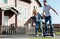 Excited man riding hoverboard and holding wifes hand