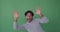 Excited man waving both hands on green background