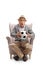 Excited mature man holding a football and sitting in an armchair