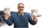 Excited mature man holding stacks of money in front of a photovoltaic farm