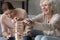 Excited mature woman with adult daughter playing funny board game