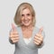 Excited mature woman showing thumbs up